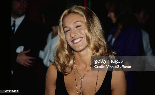 American actress Sarah Jessica Parker, wearing a black dress with a scoop neckline, attends the Hollywood premiere of 'Honeymoon in Vegas,' held at...