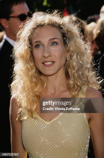 American actress Sarah Jessica Parker, wearing a yellow dress with gold thread detail, attends the 51st Primetime Emmy Awards, held at the Shrine...