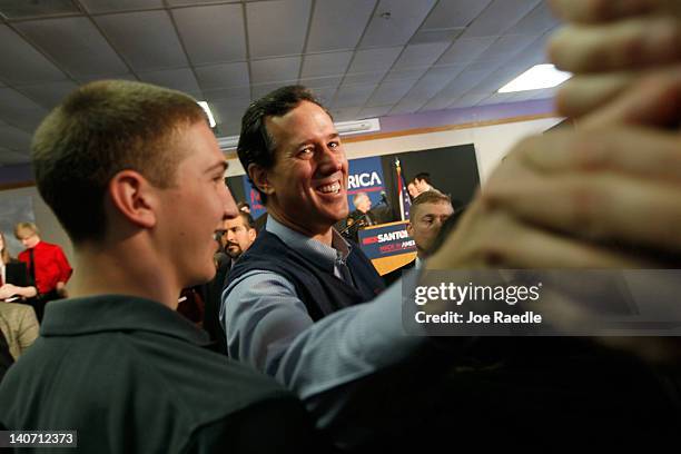 Republican presidential candidate, former U.S. Sen. Rick Santorum greets people during a campaign rally at the Dayton Christian School on March 5,...