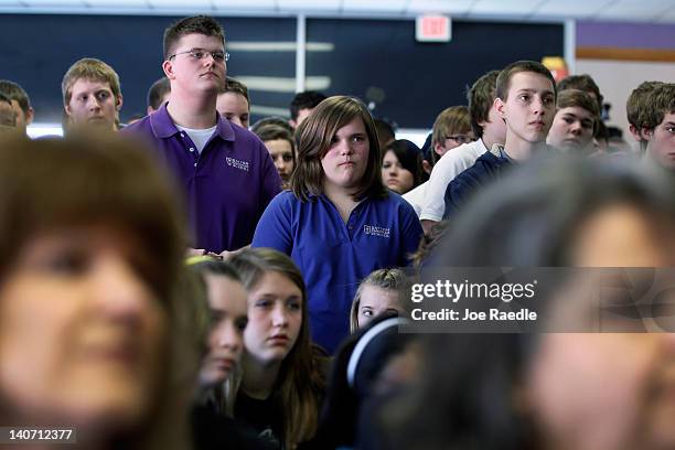 People listen as Republican presidential candidate, former U.S. Sen. Rick Santorum speaks during a campaign rally at the Dayton Christian School on...