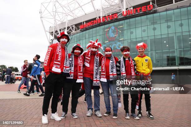 Austria fans wearing hats and face paint pose for a photo outside the stadium prior to the UEFA Women's Euro England 2022 group A match between...