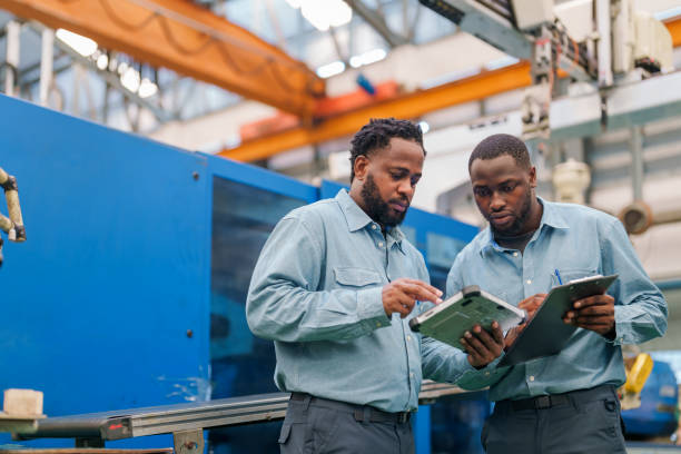 How to Start a Production Company in South Africa 1 senior engineer explaining machine functioning to new engineer