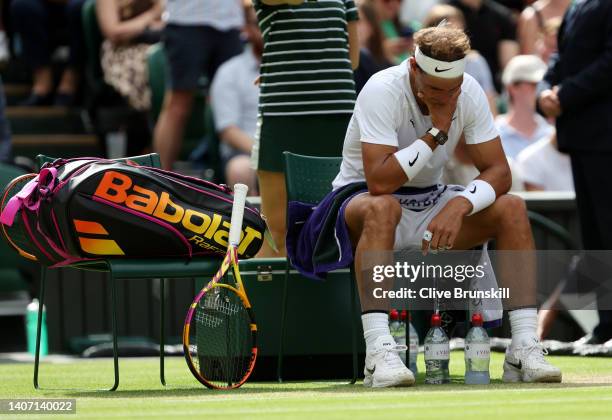 Rafael Nadal of Spain reacts after indicating an injury during a break against Taylor Fritz of The United States during their Men's Singles Quarter...