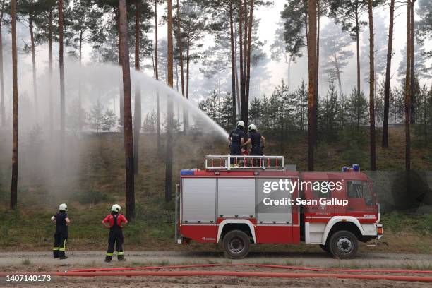 Firefighters seek to contain a forest fire on July 06, 2022 near Lieberose, Germany. Fire crews are currently hampered because the fire, which has so...