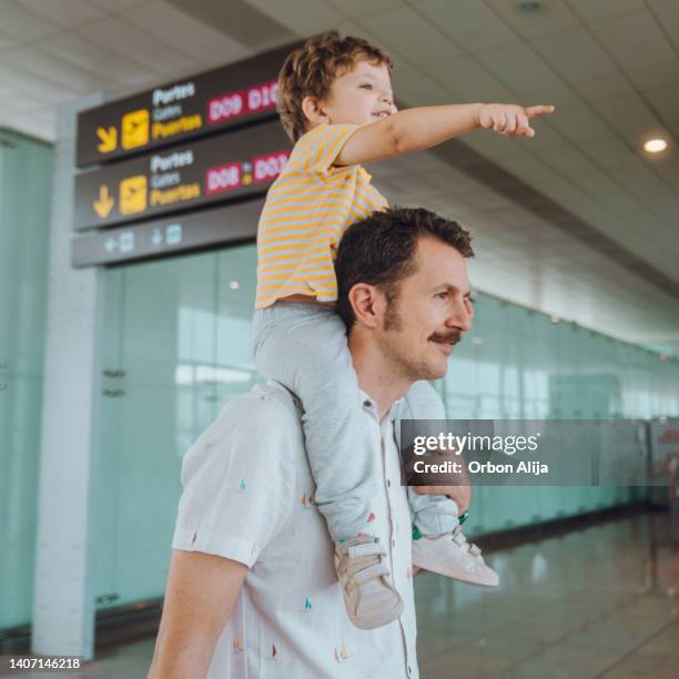 father with his son at the airport - baby father hug side stock pictures, royalty-free photos & images