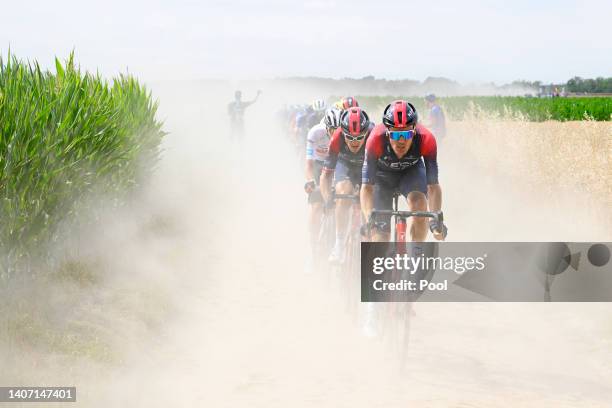 Geraint Thomas of The United Kingdom and Dylan Van Baarle of Netherlands and Team INEOS Grenadiers compete passing through a cobblestones sector...
