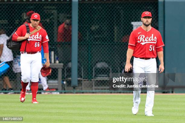 Joel Kuhnel and Hunter Strickland of the Cincinnati Reds walks to the dugout after the game against the Atlanta Braves at Great American Ball Park on...