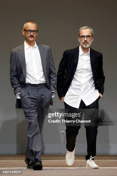 Designers Viktor Horsting and Rolf Snoeren walk the runway at the end of the Viktor & Rolf Haute Couture Fall Winter 2022 2023 show as part of Paris...