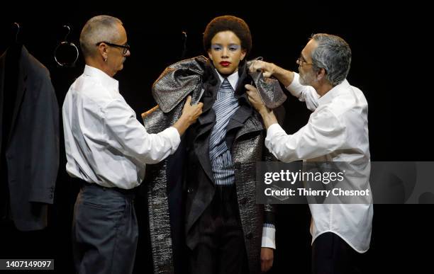 Designers Viktor Horsting and Rolf Snoeren adjust the garment of a model during the Viktor & Rolf Haute Couture Fall Winter 2022 2023 show as part of...