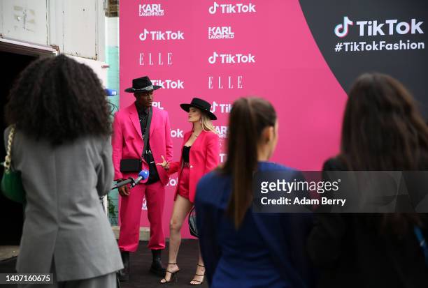 Participants walk along a red carpet as they attend an event called "The Future of Fashion" held by the short-form video hosting service TikTok, on...