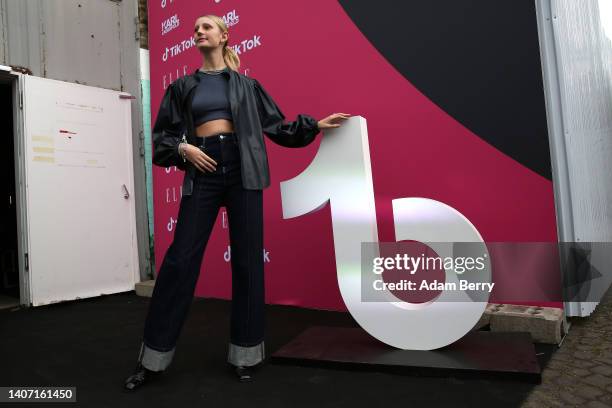 Model Trixi Giese poses with the logo of the short-form video hosting service TikTok at an event called "The Future of Fashion" on July 06, 2022 in...