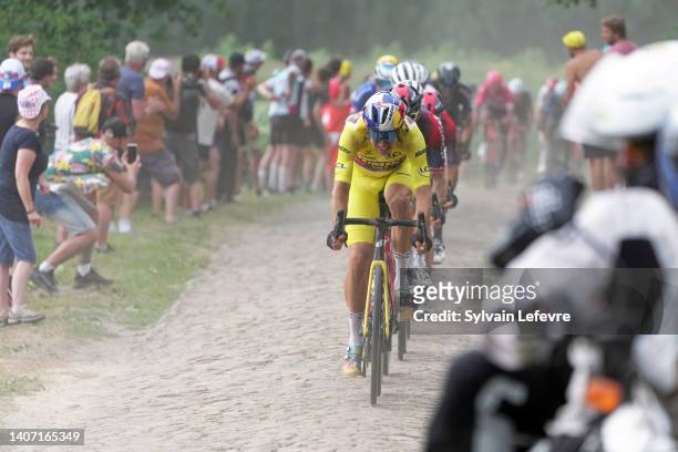 Wout Van Aert of Belgium and Team Jumbo - Visma - Yellow Leader Jersey competes passing through the cobblestones sector of Wallers during the 109th...