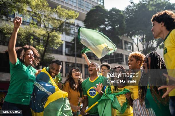 brazilian fans celebrate a goal of the soccer match - street football stock pictures, royalty-free photos & images