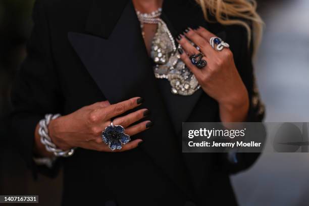 Corina Mihaila Larpin seen wearing a black embroidered short blazer dress, a silver pendant necklace from Stéfère Jewelry, a diamond large bracelet...