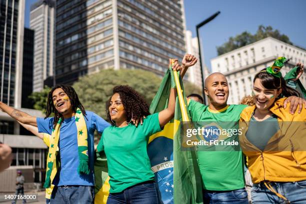 brazilian fans celebrating a soccer game outdoors - street football stock pictures, royalty-free photos & images