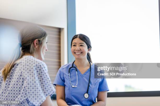 nurse smiles proudly to her patient - patientkontakt bildbanksfoton och bilder