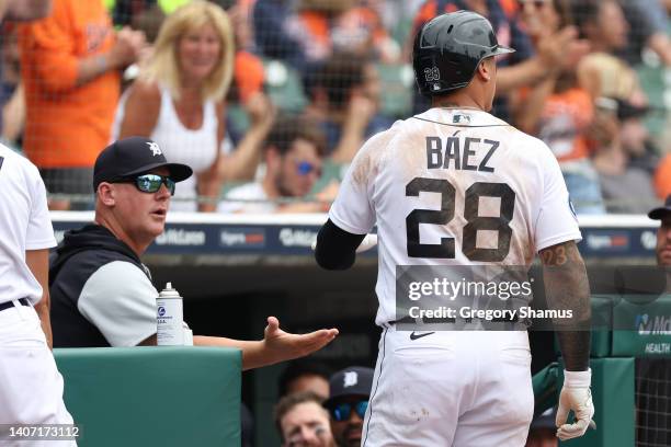 Javier Baez of the Detroit Tigers celebrates scoring a fifth inning run with manager s while playing the Cleveland Guardians at Comerica Park on July...