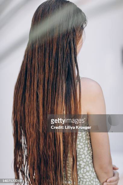rear view of a girl in a swimsuit with beautiful long hair. - straight hair ストックフォトと画像