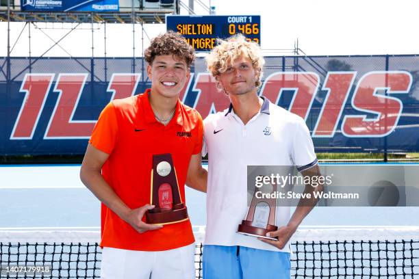 Ben Shelton of the Florida Gators poses with his national champion trophy alongside August Holmgren of the San Diego Toreros and his national runner...