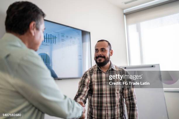 businessmen on a handshake at work - successful candidate stock pictures, royalty-free photos & images