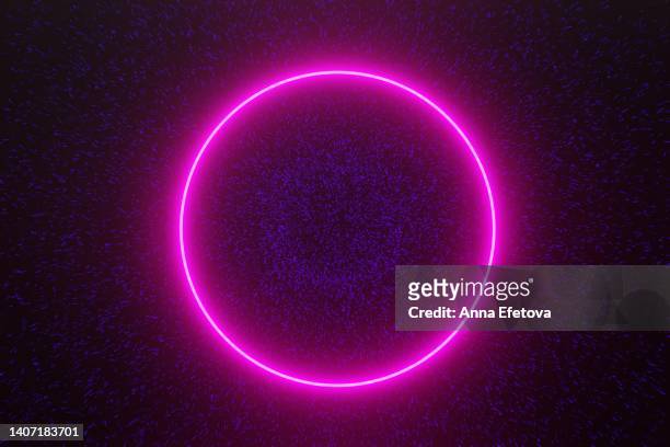 magenta neon circle on glittering background with blue particles - fluorescente foto e immagini stock