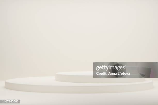 white podiums on beige background. - pyramid shapes around the house stock pictures, royalty-free photos & images