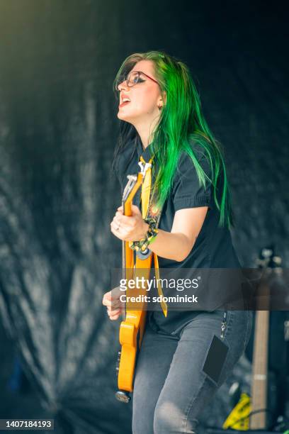 female bass player performing live concert - emo stock pictures, royalty-free photos & images