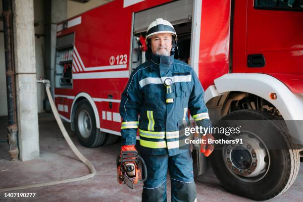 firefighter in the fire station - fire station interior stock pictures, royalty-free photos & images