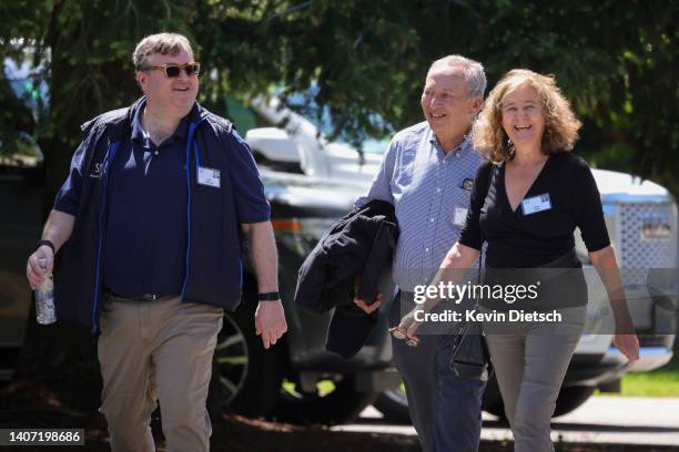 Reid Hoffman, co-founder and executive chairman of LinkedIn; former U.S. Treasury Secretary Larry Summers; and his wife Elisa New walk together...