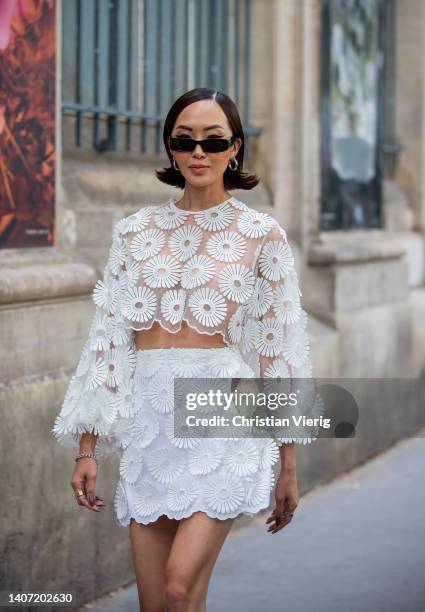 Chriselle Lim seen wearing sheer white top, mini skirt outside Elie Saab during Paris Fashion Week - Haute Couture Fall Winter 2022 2023 : Day Three...