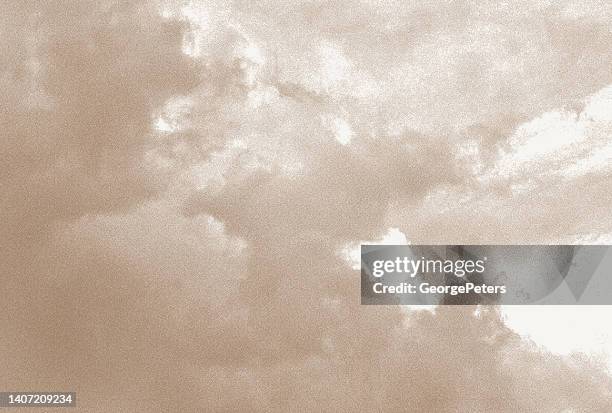 stipple illustration of storm clouds - sepia toned background stock illustrations