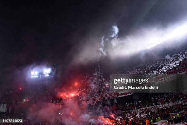Fans of River Plate light flares during a Copa Libertadores round of sixteen second leg match between Velez and River Plate at Estadio Monumental...