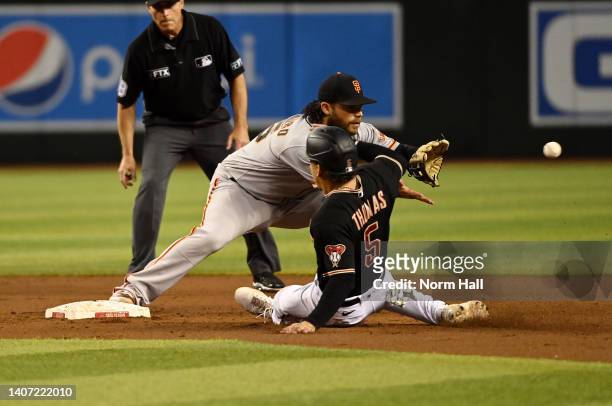 Brandon Crawford the San Francisco Giants forces out Alek Thomas of the Arizona Diamondbacks at second base in `the second inning at Chase Field on...