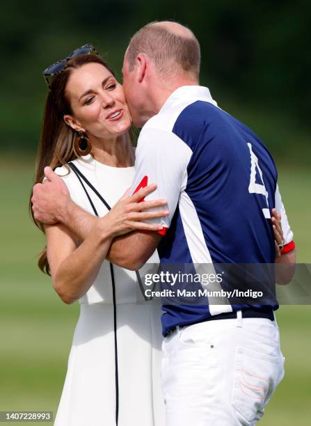 Catherine, Duchess of Cambridge kisses Prince William, Duke of Cambridge during the prize-giving of the Out-Sourcing Inc. Royal Charity Polo Cup at...