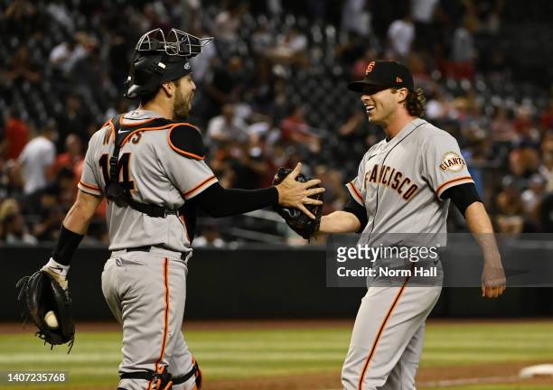 Sam Long and Austin Wynns of the San Francisco Giants celebrate a 7-5 win against the Arizona Diamondbacks at Chase Field on July 06, 2022 in...
