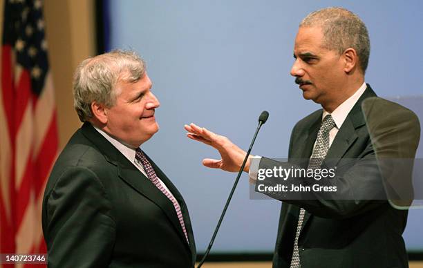 Attorney General Eric Holder talks with an unidentified man before speaking at Northwestern Law School March 5, 2012 in Chicago, Illinois. Holder was...