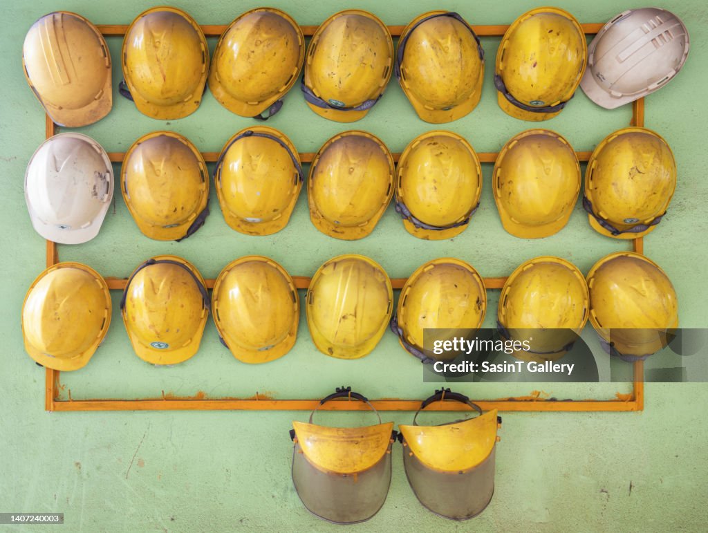 Row of safety helmets in factory