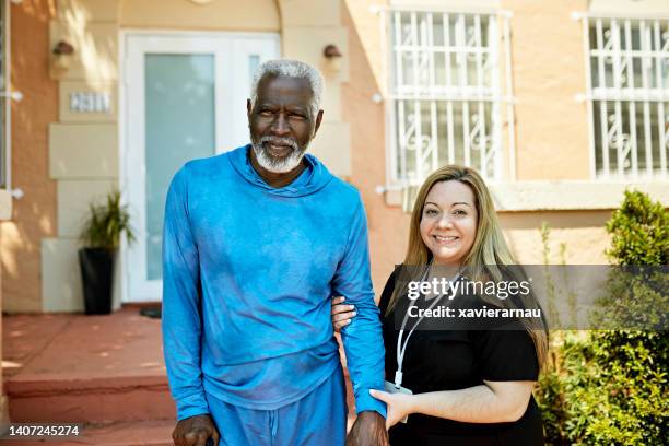 outdoor portrait of miami senior and home caregiver - residential care stock pictures, royalty-free photos & images