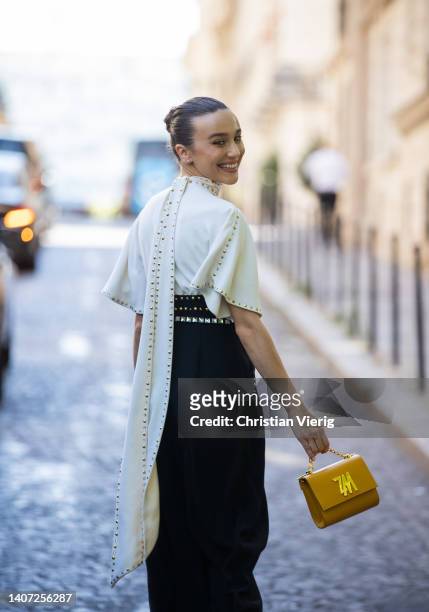 Mary Leest seen wearing white top, black high waisted pants, orange bag outside Zuhair Murad during Paris Fashion Week - Haute Couture Fall Winter...