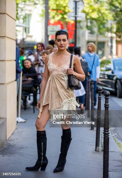 Maria Bernad seen wearing asymmetric beige dress, black back, mid high boots, knee socks black outside Viktor&Rolf during Paris Fashion Week - Haute...