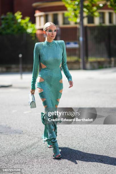 Leonie Hanne wears silver and diamonds B logo earrings from Balenciaga, a green embroidered sequins long sleeves / epaulets / cut-out sides long...