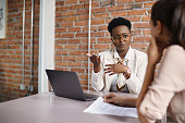 Black businesswoman talking to a candidate during job interview in the office.