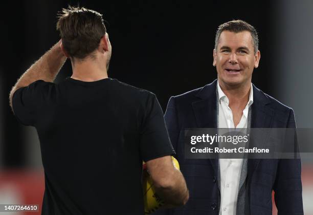 Tom Hawkins of the Cats speaks to commentator Wayne Carey prior to the round 17 AFL match between the Geelong Cats and the Melbourne Demons at GMHBA...