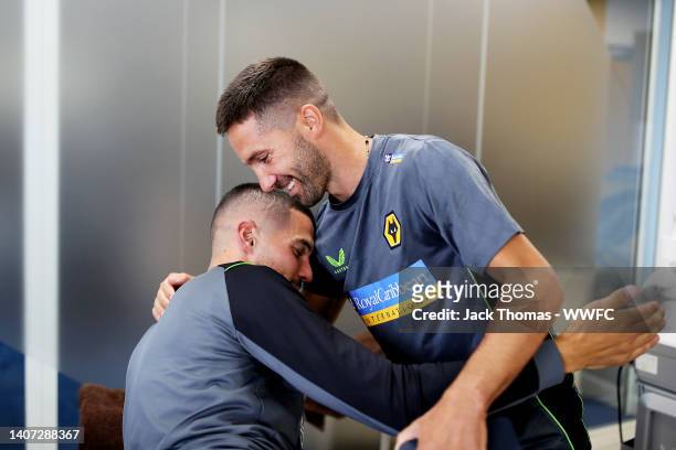 Joao Moutinho embraces Conor Coady of Wolverhampton Wanderers as they both return to Compton for pre-season training at The Sir Jack Hayward Training...