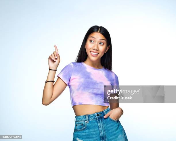 young woman in lilac tie dye top - woman index finger stock pictures, royalty-free photos & images