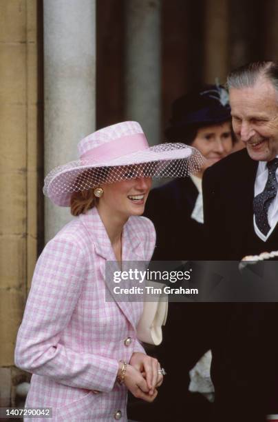 Princess Diana outside St Paul's Cathedral where she is attending a service for The Children's Society, 2nd October 1990. She is wearing a pink and...