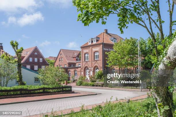 germany, lower saxony, juist, empty town street in summer with altes warmbad office in background - east frisian islands stock pictures, royalty-free photos & images