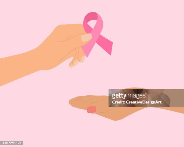illustrazioni stock, clip art, cartoni animati e icone di tendenza di concetto di sensibilizzazione sul cancro al seno. mano femminile che dà il nastro rosa del cancro ad un'altra mano. - seno