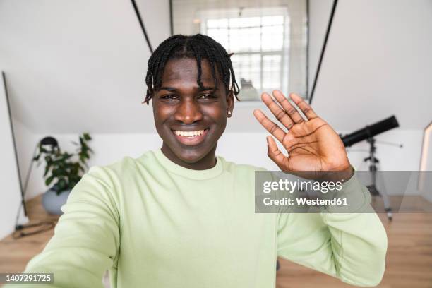 happy man waving at home - 手を振る　男性 ストックフォトと画像