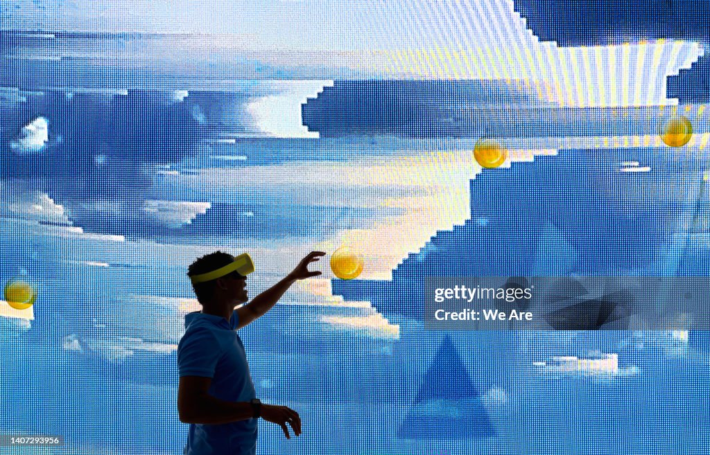 Silhouette of a man interacting with virtual computer graphics